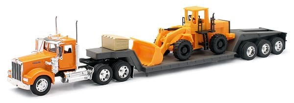 A toy truck with a large yellow tractor on it's trailer.