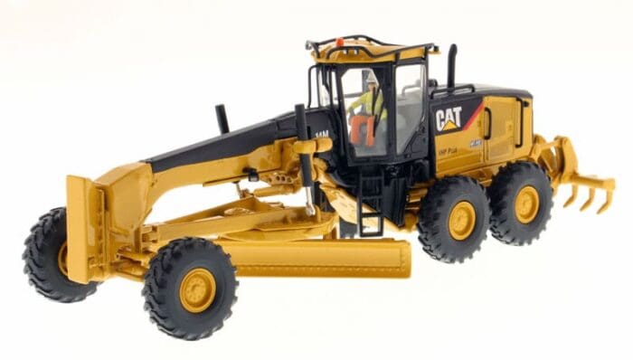 A yellow and black cat construction vehicle with a man in the back.