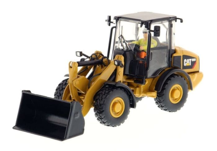 A toy wheel loader with a man in the cab.