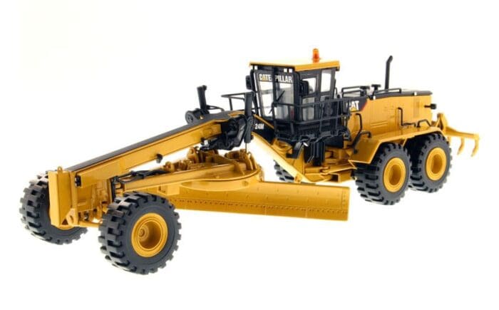 A yellow and black toy tractor is on the ground