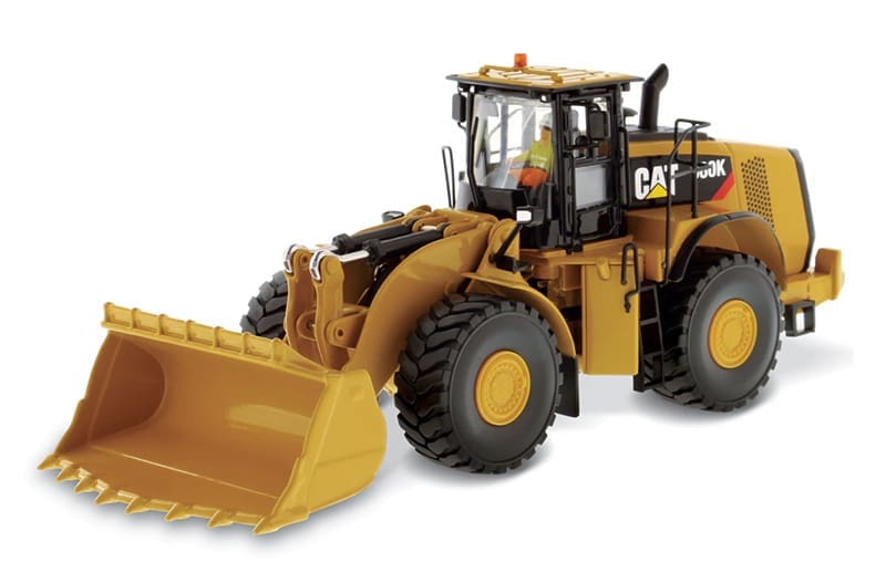 A cat 9 8 0 k wheel loader with operator and bucket.