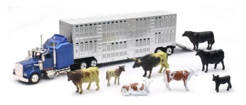 A toy truck with cows and cattle in front of it.
