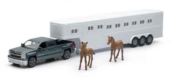 A horse trailer with two horses and a truck.