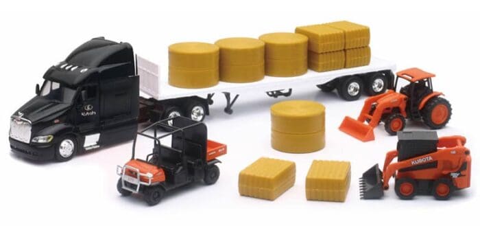 A toy truck and trailer with stacks of yellow barrels.