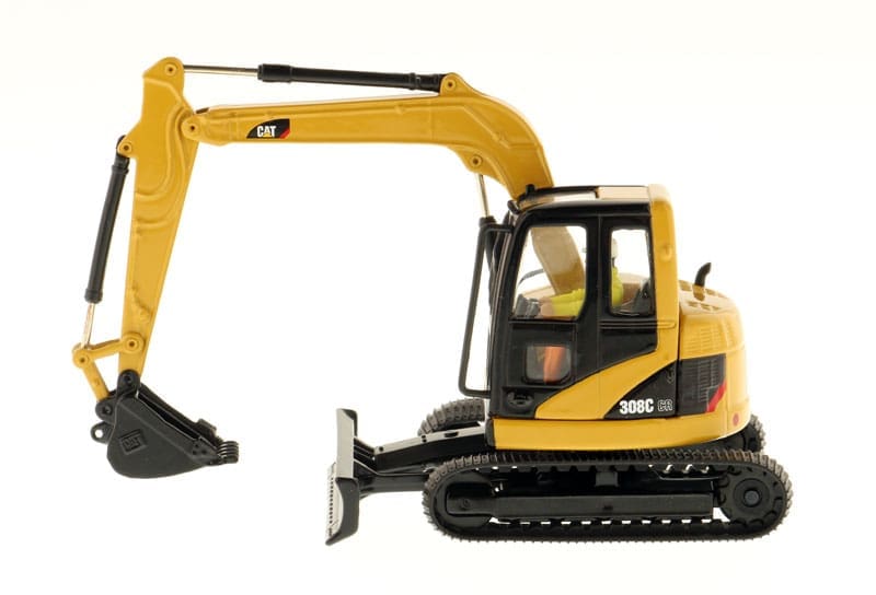 A yellow and black toy excavator is on display.