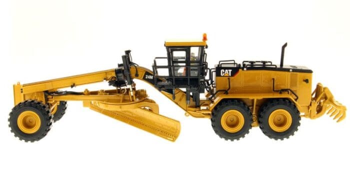 A yellow and black cat grader is on the ground