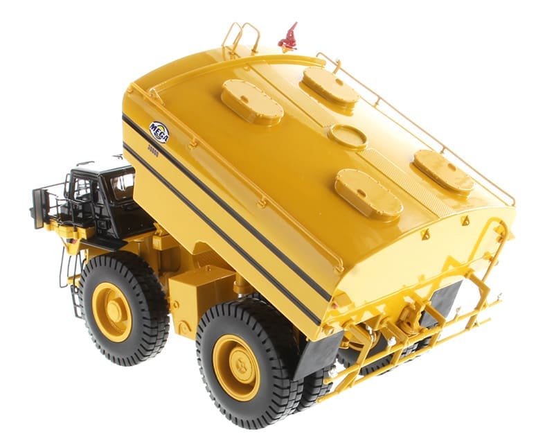 A yellow dump truck with a large tank on the back.