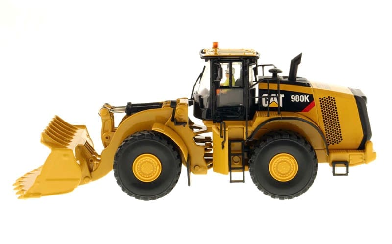 A yellow cat 9 8 0 k wheel loader with a bucket.