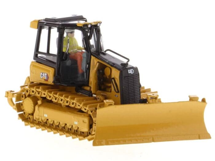 A cat bulldozer with a worker on the front.