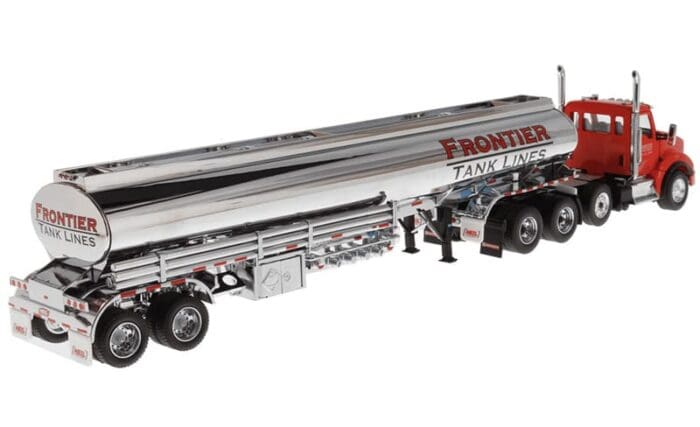 A silver semi truck with a long trailer.
