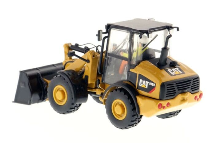 A yellow and black cat wheel loader with a cab.