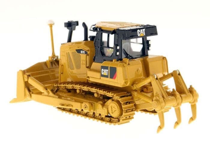 A yellow and black cat bulldozer with a plow.