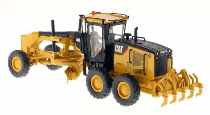 A yellow and black cat grader is parked.