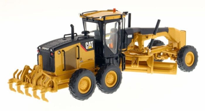 A yellow and black cat grader is on the ground