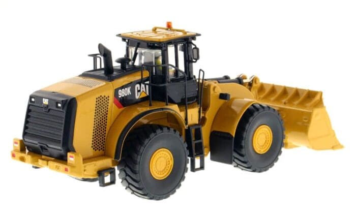 A yellow and black cat wheel loader is parked.
