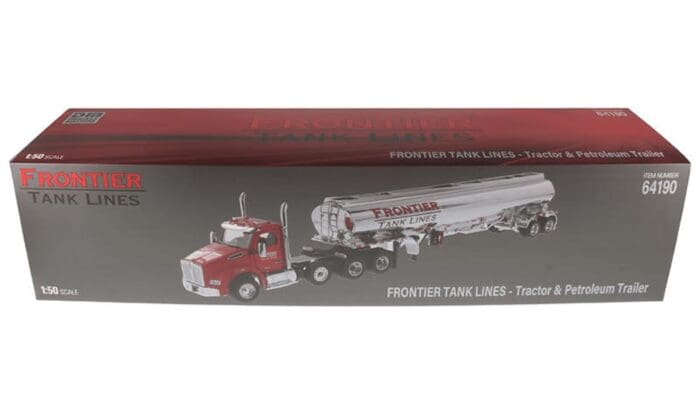 A red and silver truck is parked next to a tanker trailer.