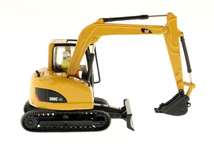 A yellow and black toy excavator is on the floor