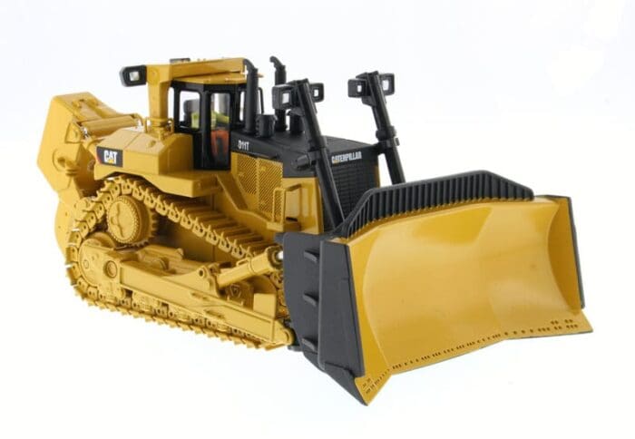 A yellow and black toy bulldozer on display.