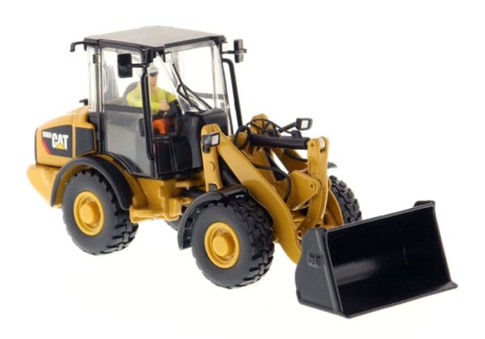 A toy wheel loader with its bucket on the back.