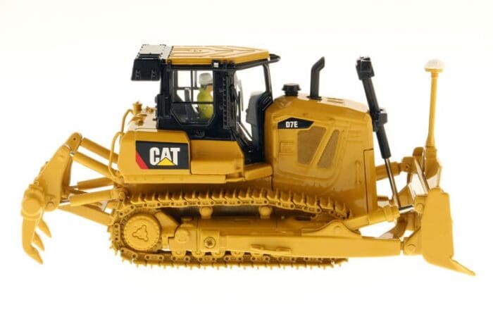 A yellow cat tractor is on display in the studio.