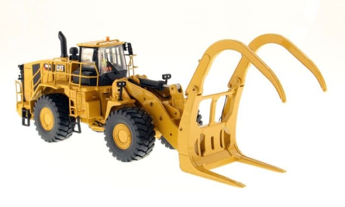 A yellow tractor with a fork in it