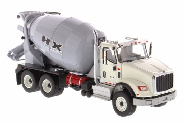 A cement truck is parked on the side of the road.