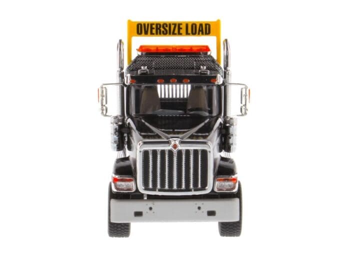 A large truck with an oversize load sign on the front.