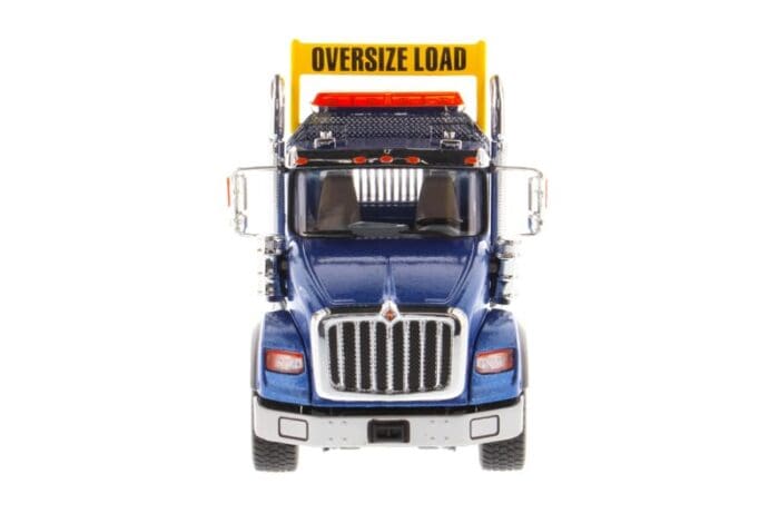 A large truck with an oversize load sign on the back.