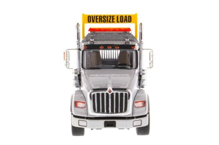 A large truck with an oversize load sign on the front.