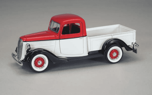 A red and white truck is parked on the floor.