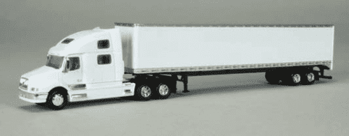 A white semi truck with its trailer on the road.