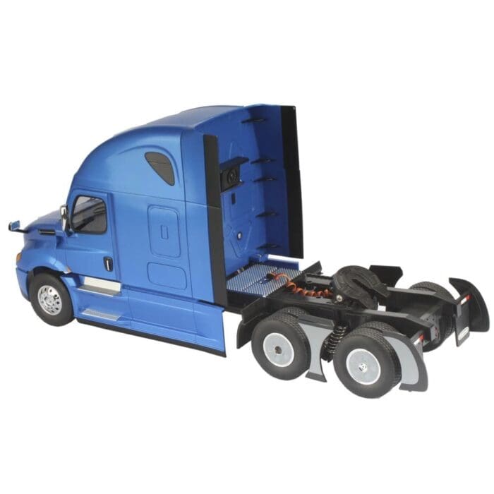A blue truck with its cab open and the front end of it.