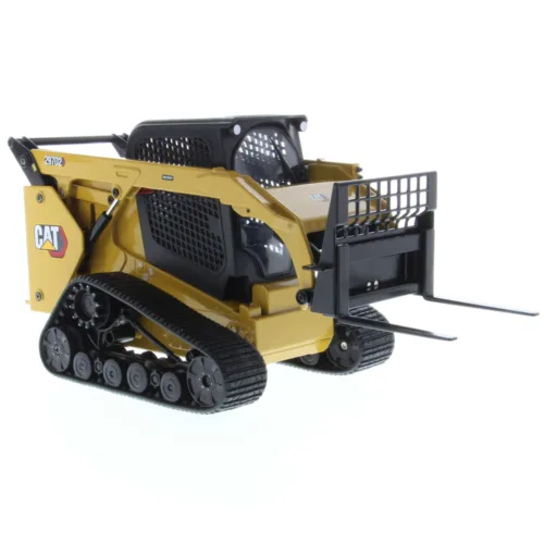 A yellow cat skid steer with a fork in the back.